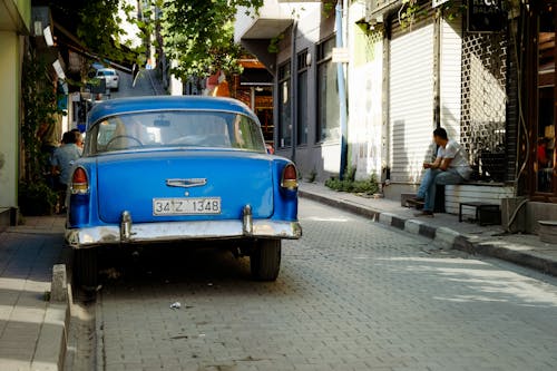 Free Vintage Blue Car Parked on Roadside Stock Photo