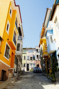 Vibrant city alley with colorful buildings under a clear blue sky, ideal for urban and travel themes.