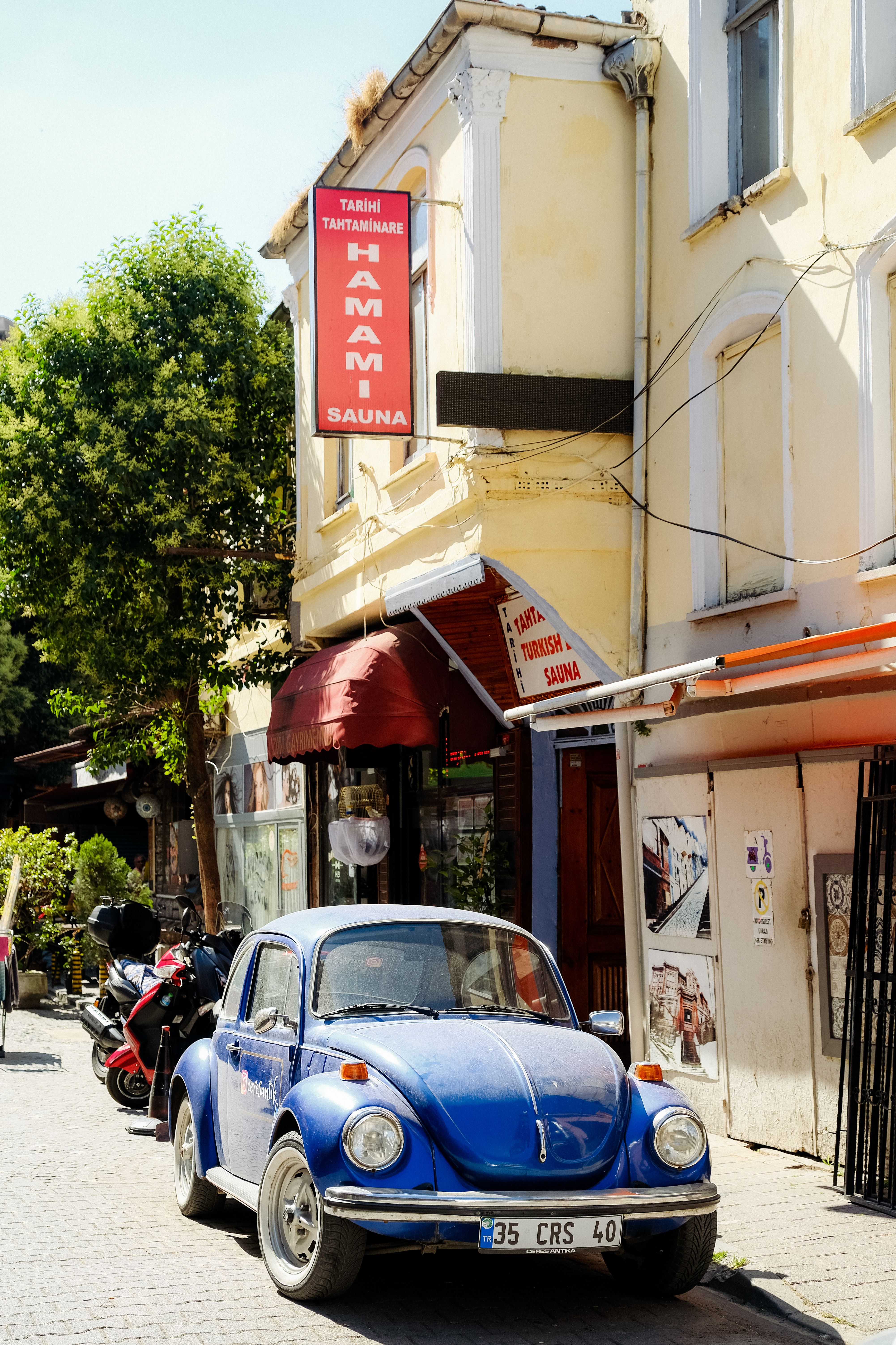 A Blue Volkswagen Beetle Parked in the Street · Free Stock Photo