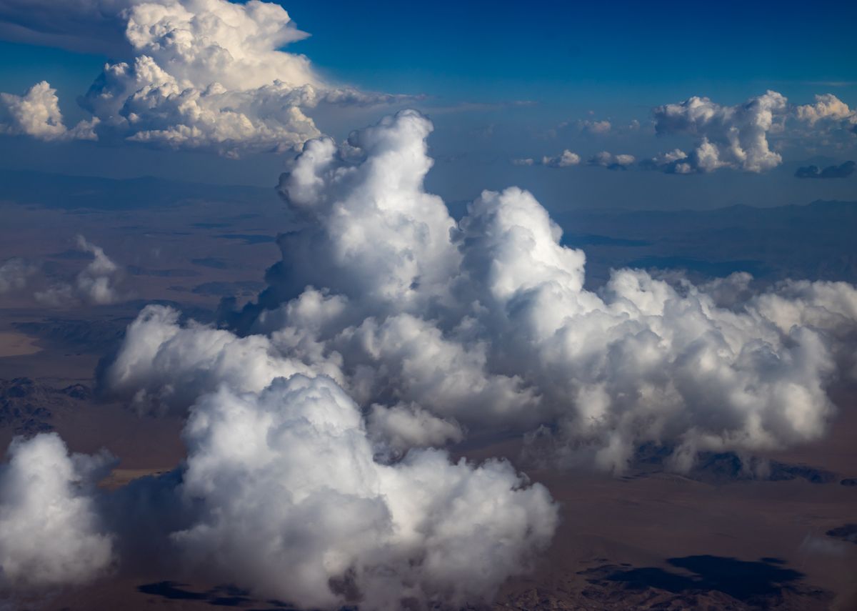 aerial view of puffy cumulus clouds over blue ocean