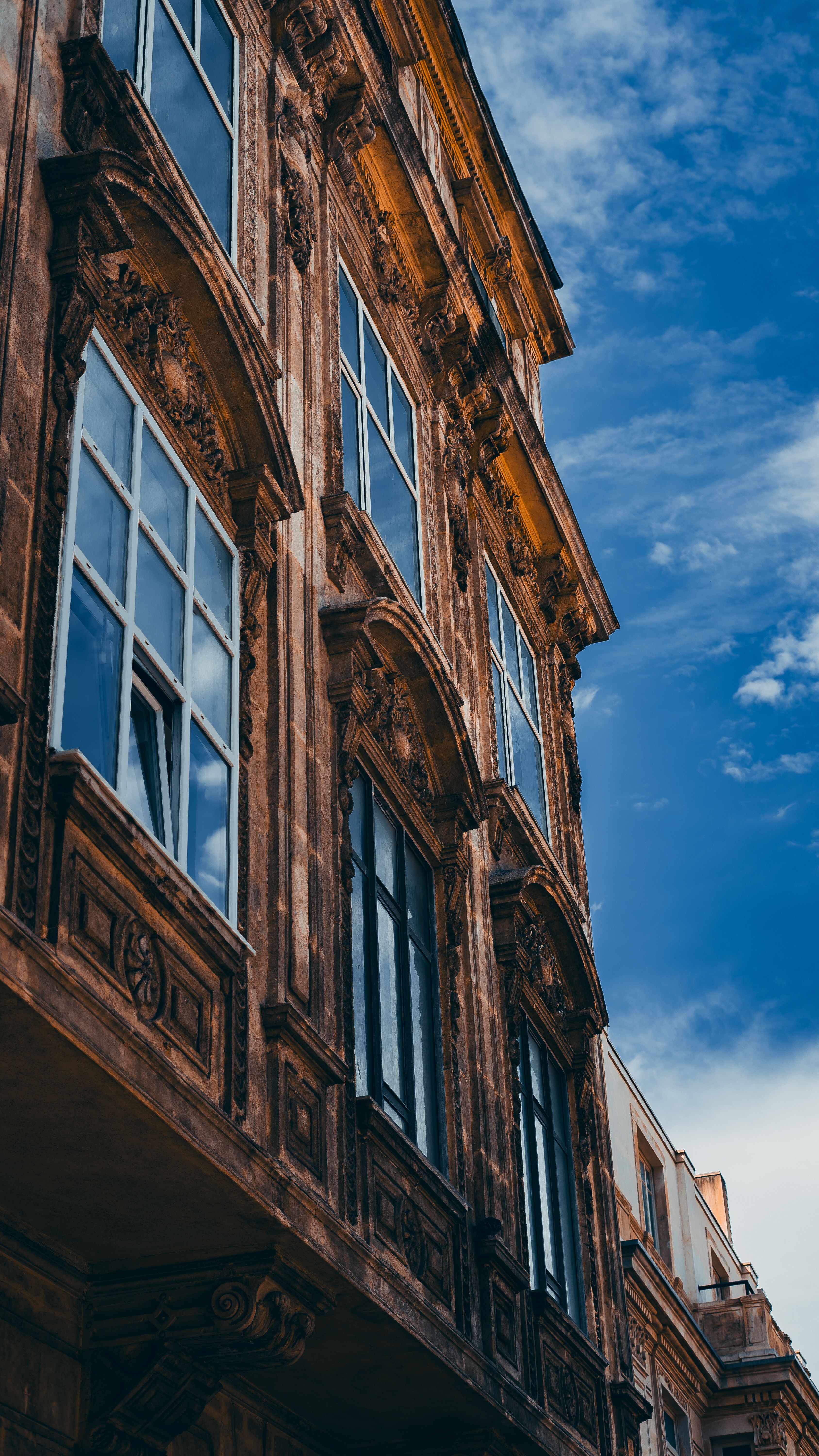 Brown Concrete Building Under Blue Sky and White Clouds · Free Stock Photo