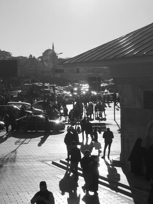 Grayscale Photo of People Walking on Sidewalk