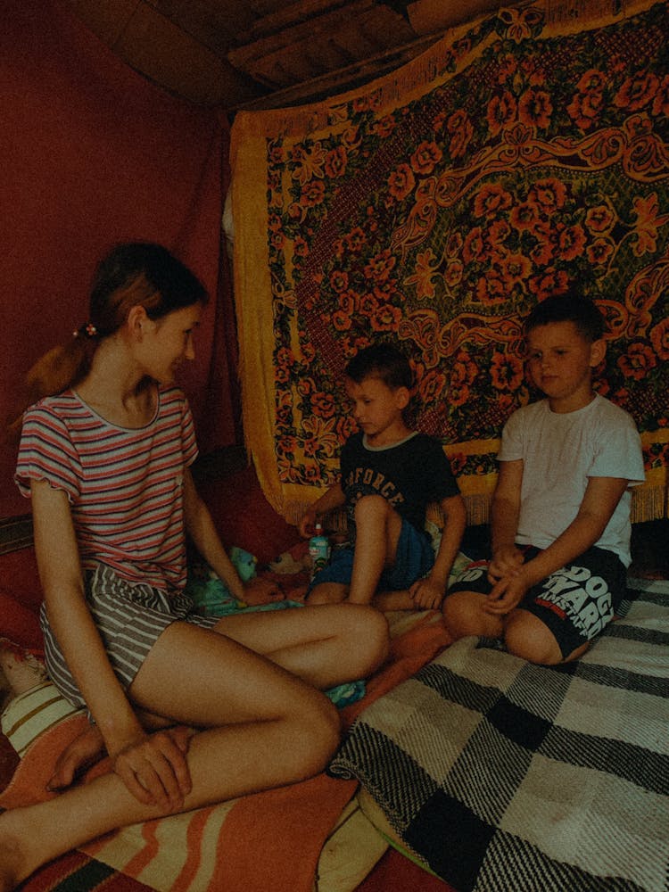 Kids Sitting On The Bed