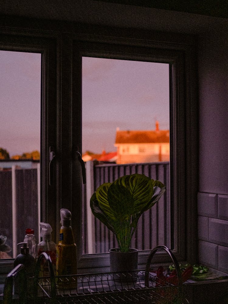 Sunset View Behind A Kitchen Window