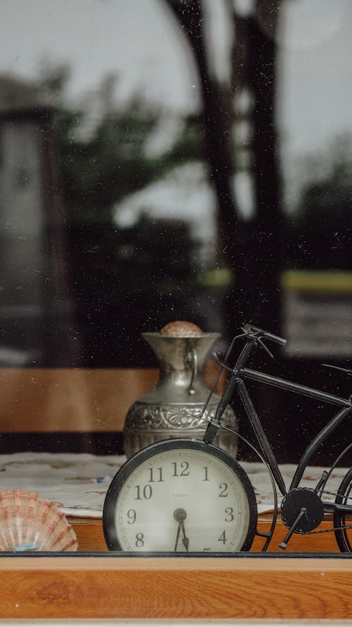 Black Metal Vintage Bicycle Clock on Wooden Table