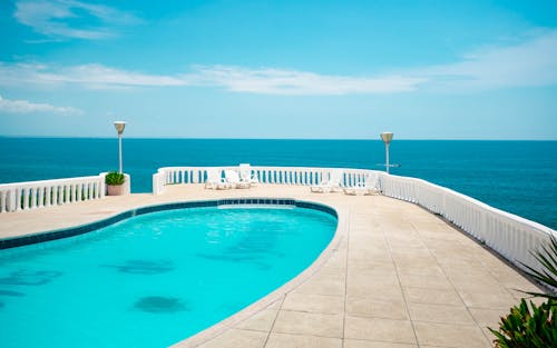 Swimming Pool Near White Wooden Fence