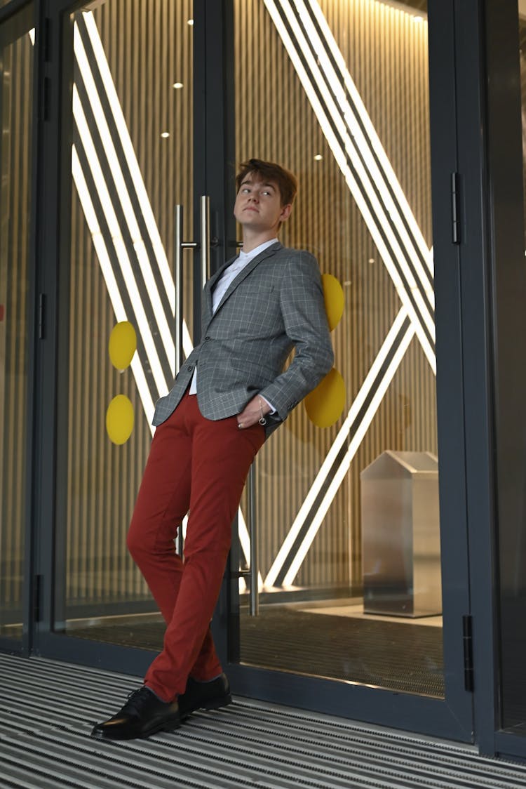 Man In Suit Leaning On Door