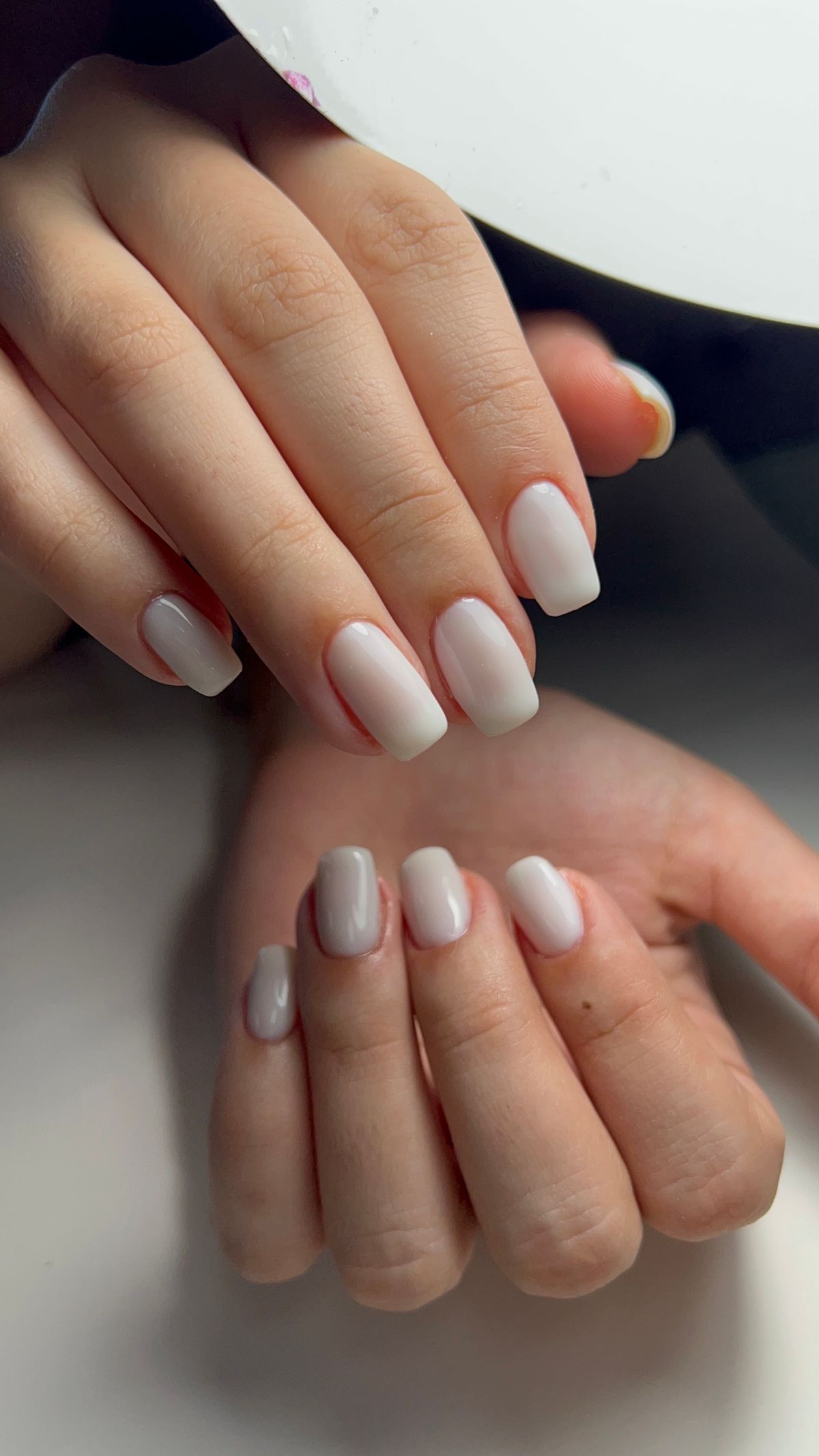 Soft pink nails under warm lamp light
