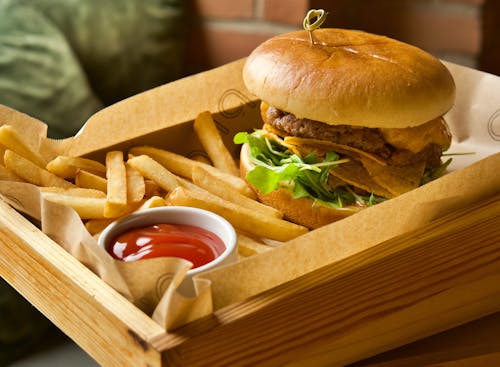 Free Burger With Fries on Brown Box Stock Photo