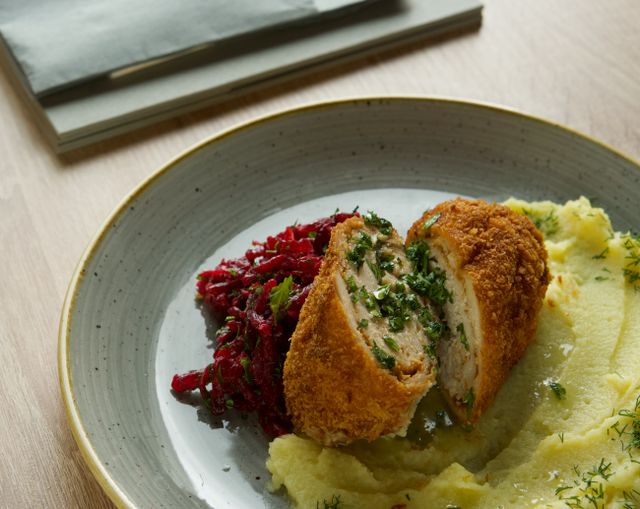 Delicious breaded chicken served with creamy mashed potatoes and beet salad.