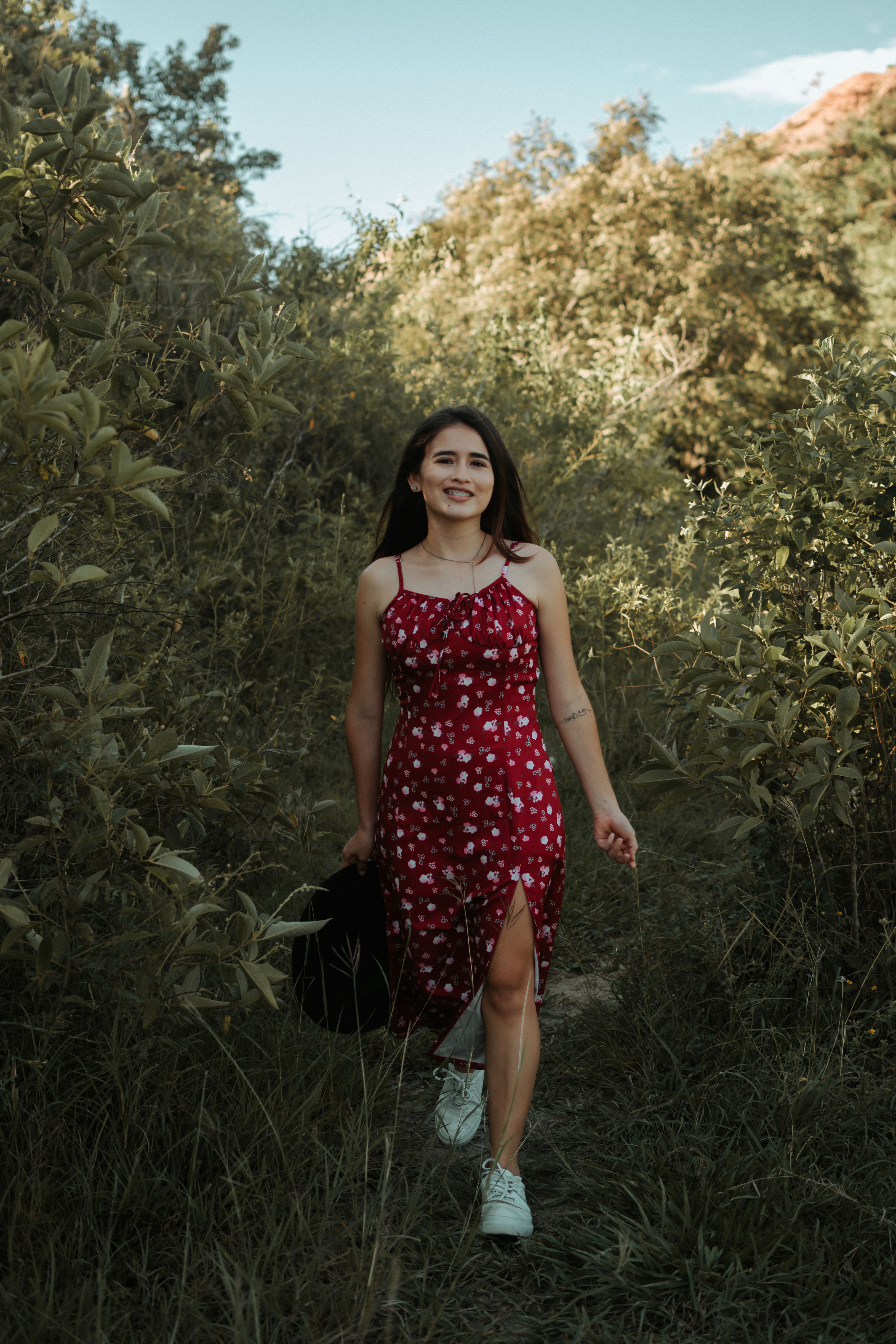 A Woman in Red Dress Walking on Grass · Free Stock Photo