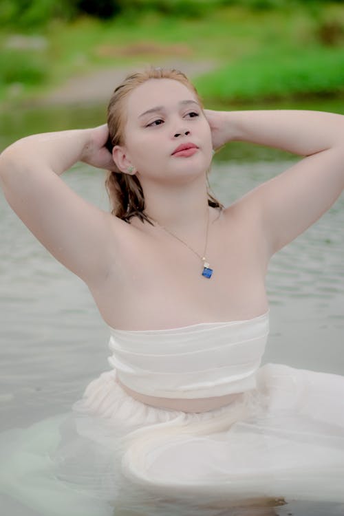 Woman in White Tube Swimming on the Lake