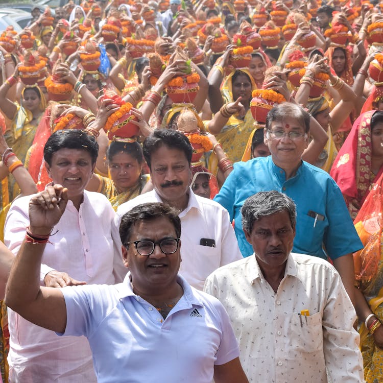 A Crowd Of People Walking Together