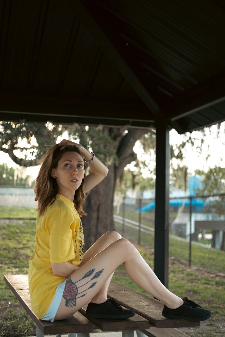 A Woman Sitting On A Table