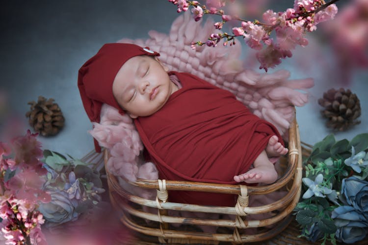 A Baby Inside A Rattan Basket