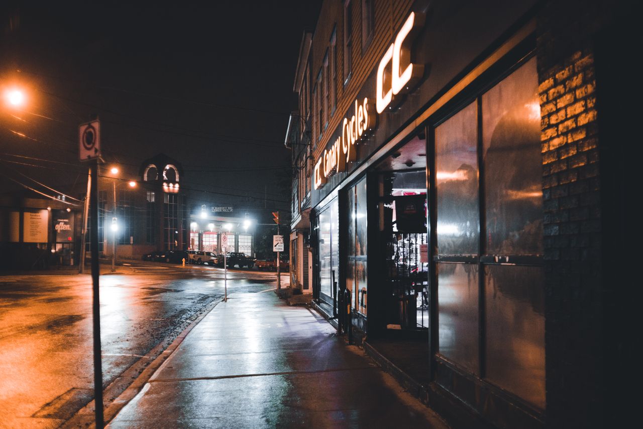 moody urban night scene with wet sidewalks and reflections on a desert