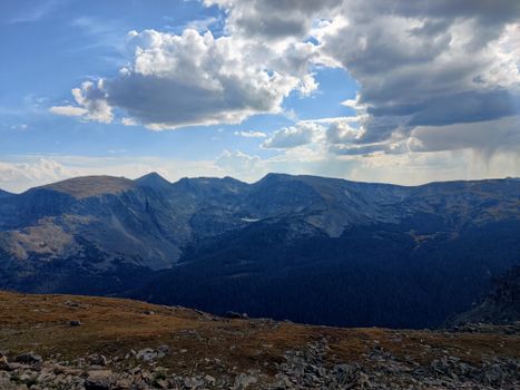 Magnificent mountain range landscape with dramatic clouds overhead, perfect for nature and travel photography.