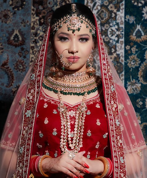 Woman in Red Traditional Dress and Jewelries Posing
