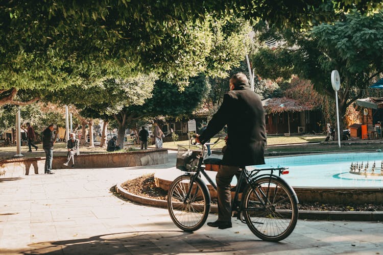 A Man Using A Bicycle In The Park