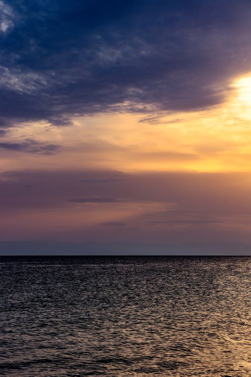 Free Stunning sunset with vivid colors over the Aegean Sea in Nea Irakleia, Greece. Stock Photo