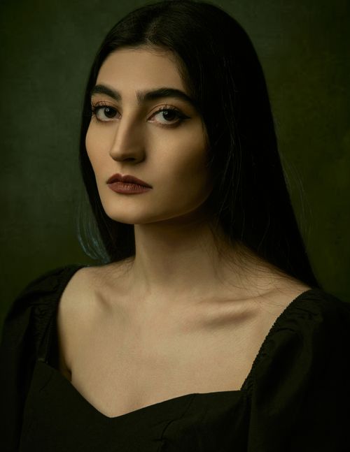 Free Striking portrait of a woman with dramatic lighting showcasing elegance and intensity. Stock Photo