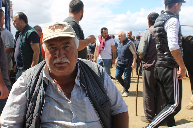 Man Sitting Among Crowd 