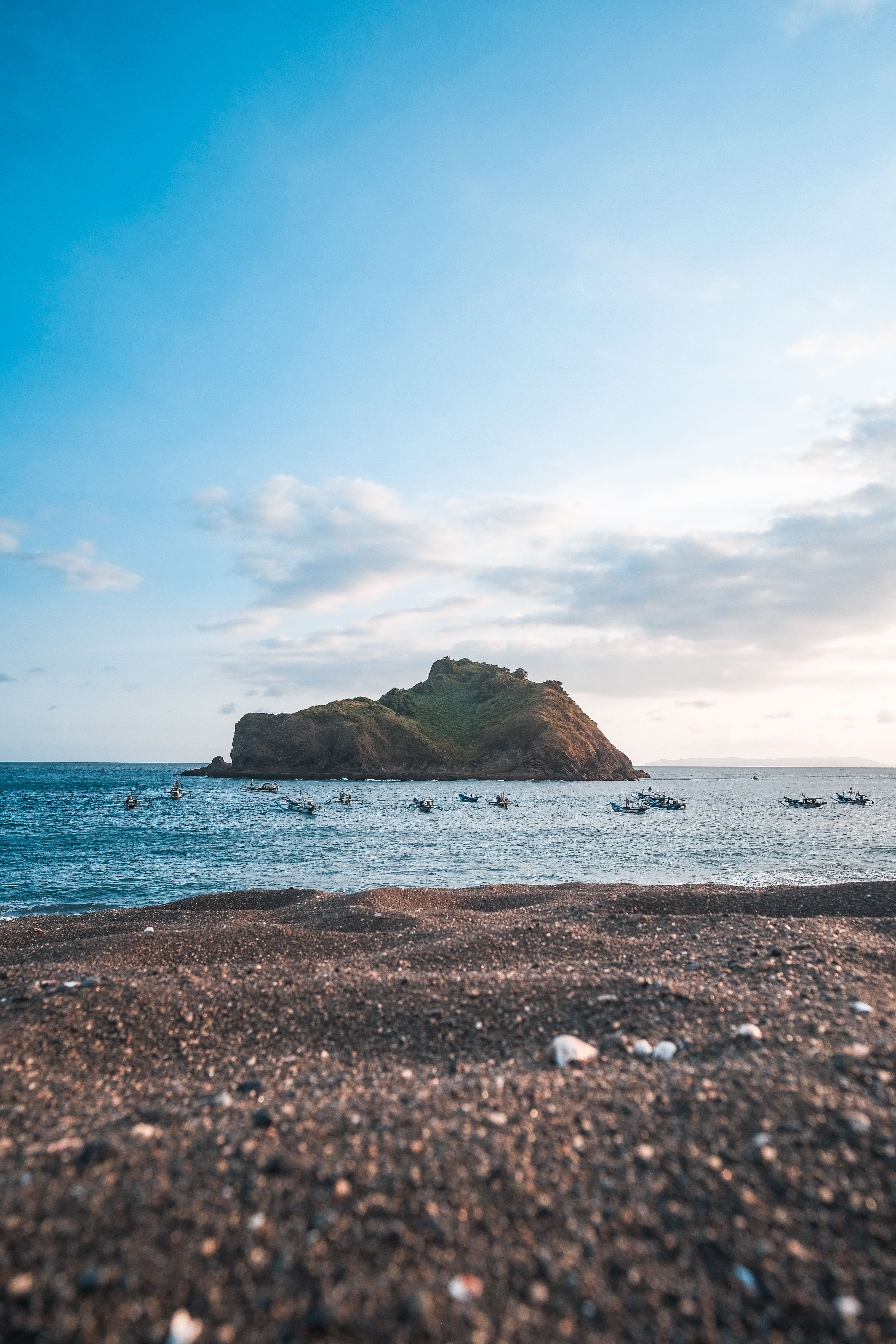 A Rock Formation in the Middle of Sea Under the Blue Sky and White ...