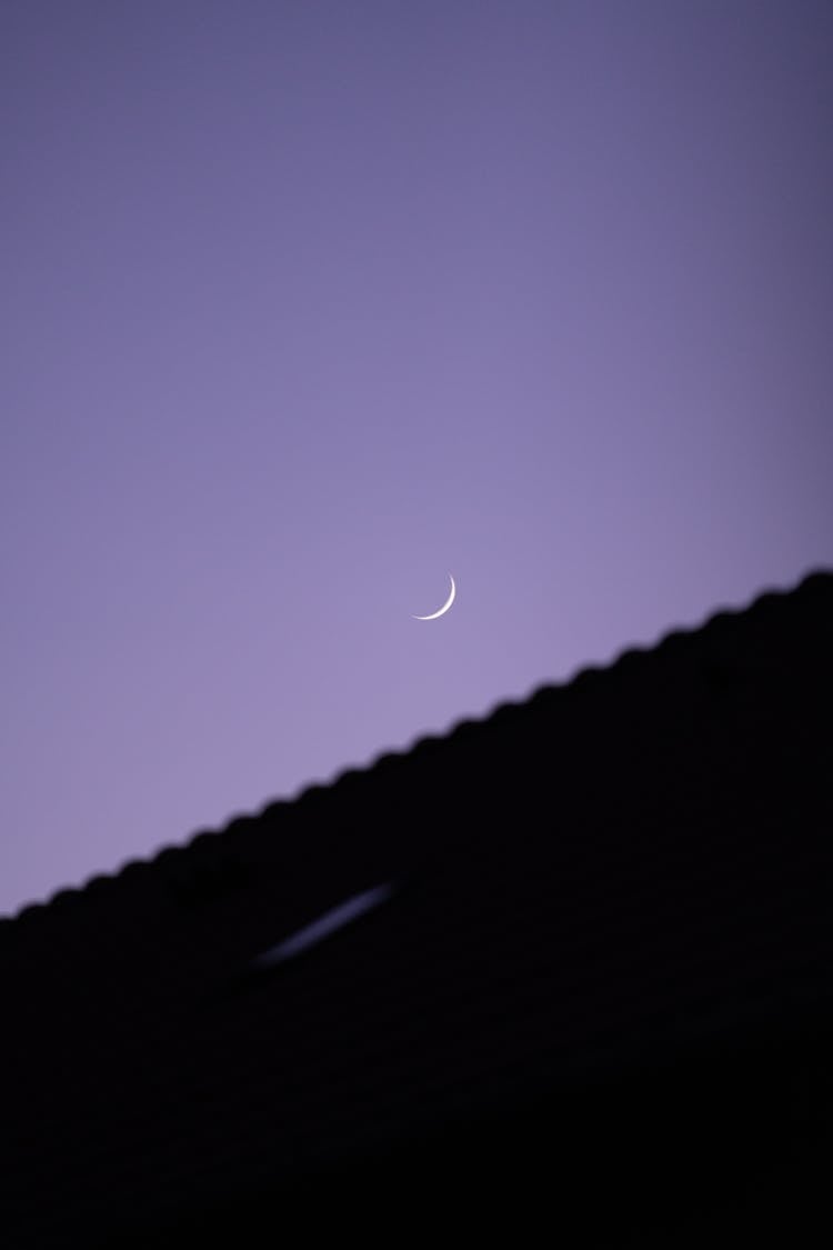 Crescent Moon Over A Roof