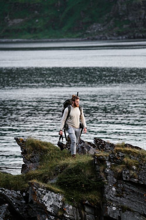 Man with a Backpack Walking on Fjords
