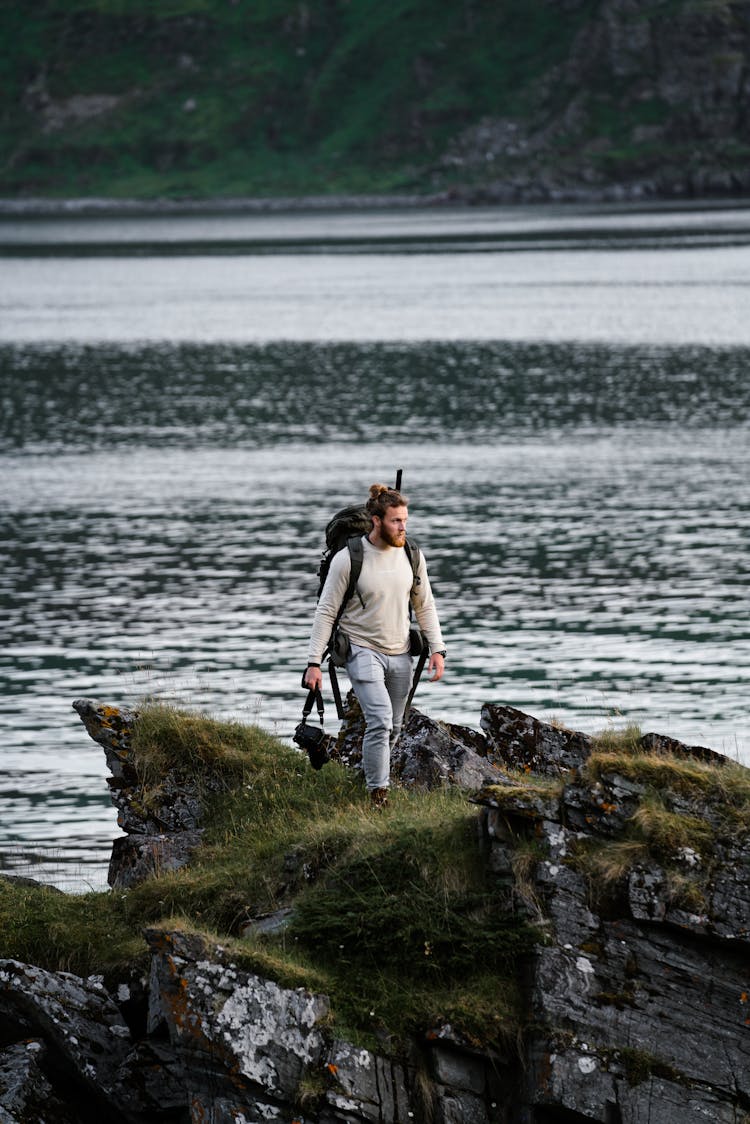 Man With A Backpack Walking On Fjords