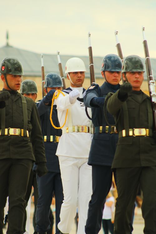 Free Soldiers marching in formation during a military parade in uniforms with rifles. Stock Photo