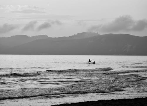 Grayscale Photo of People on Beach