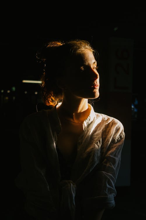 Woman in Shirt Posing in Dark