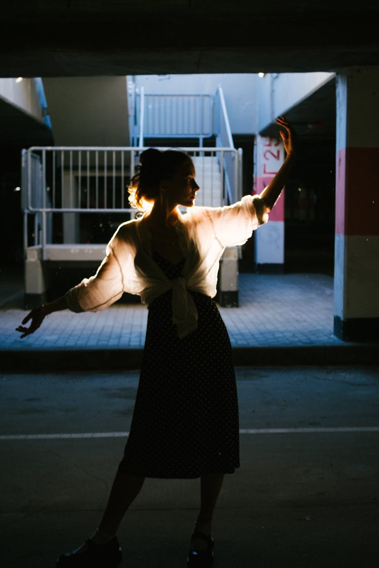 Silhouette Of Woman Dancing On Street