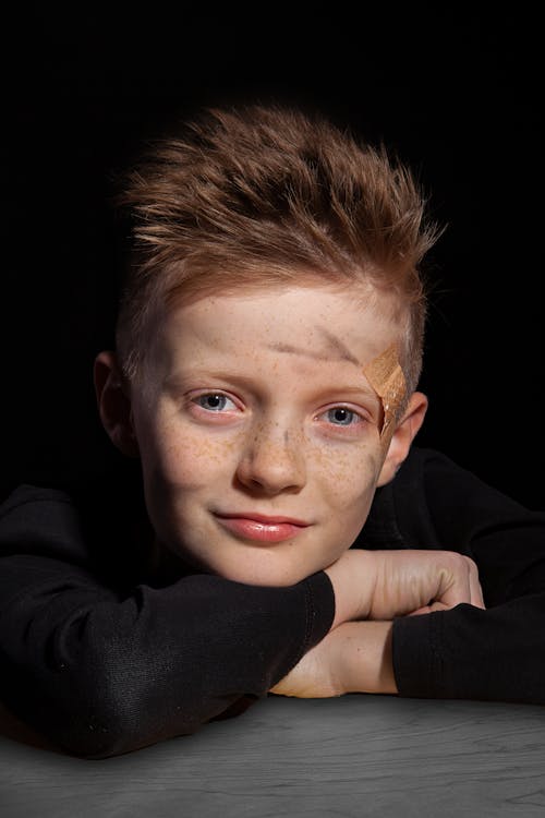 Freckled Child with a Plaster on His Temple