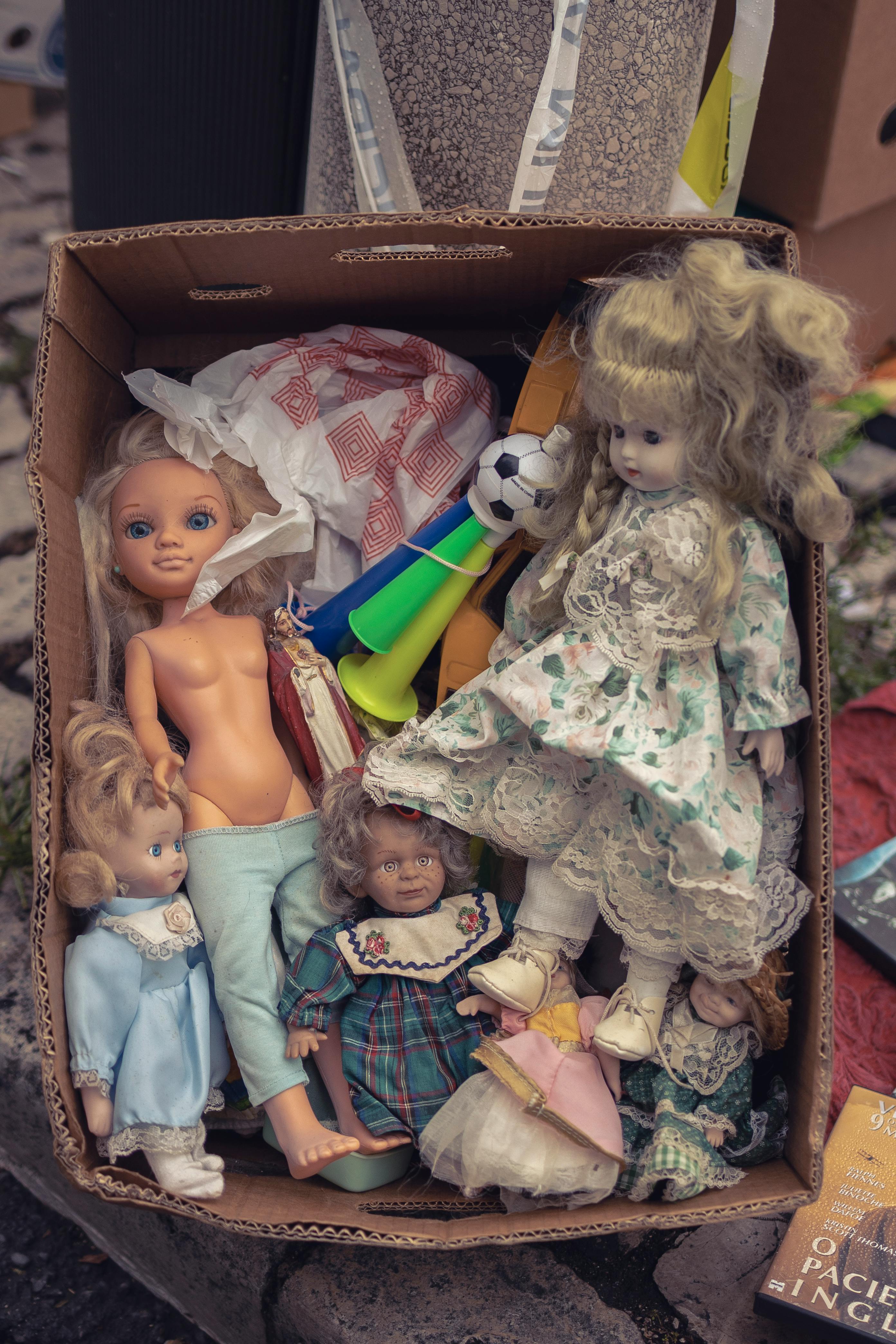 dolls in brown cardboard box