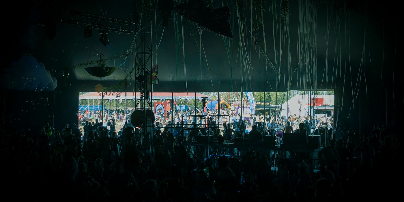 A large crowd enjoying live music at an outdoor festival