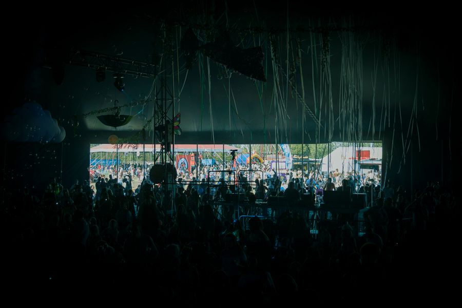 Colourful outdoor festival crowd at dusk — photo by James Frid on Pexels