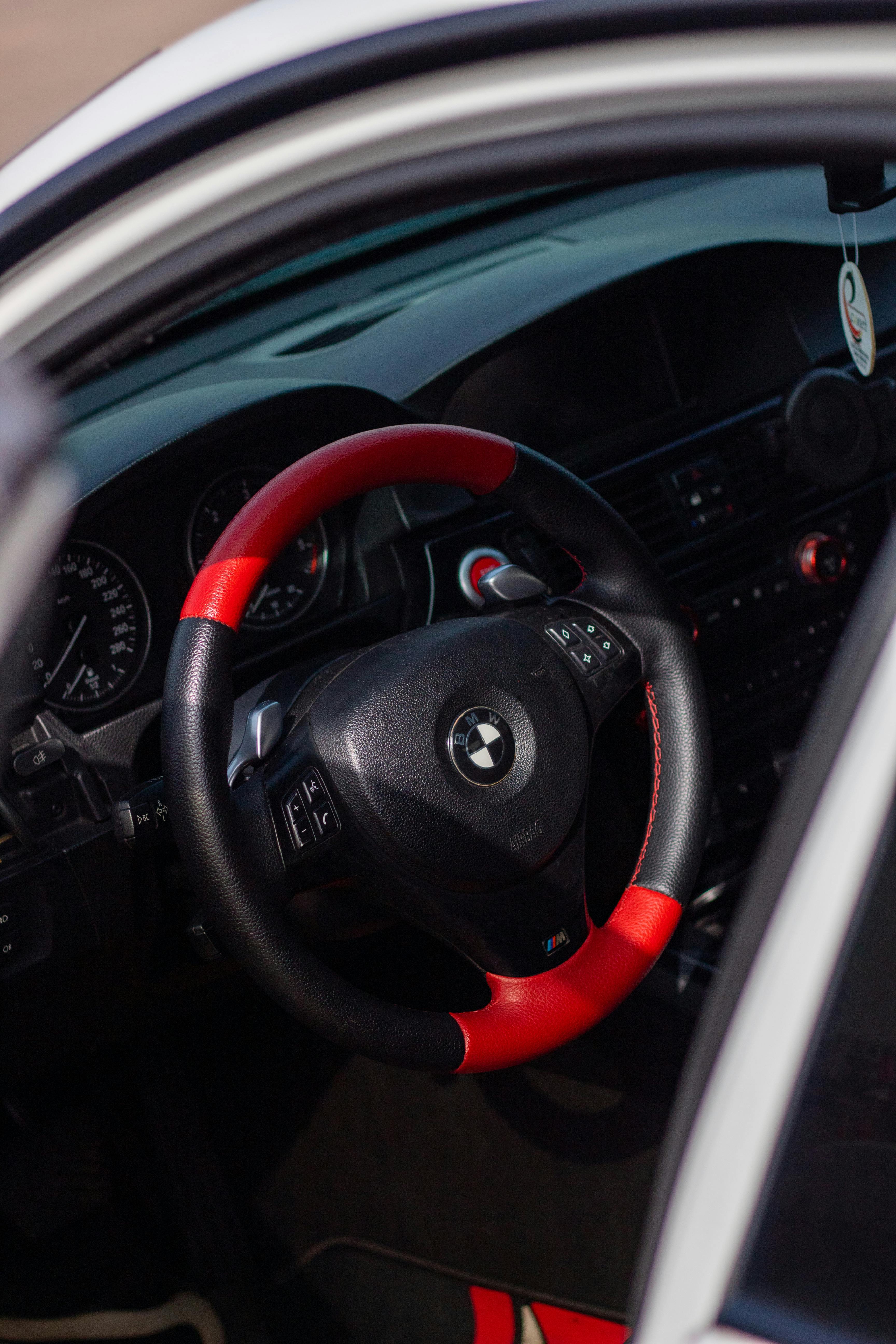 A Red and Black Steering Wheel · Free Stock Photo