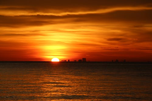 Free Photo of Sun Setting Over the Ocean Stock Photo