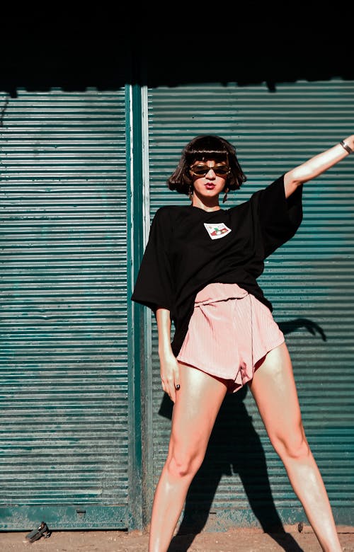 Woman wearing Shorts and Sunglasses Posing 