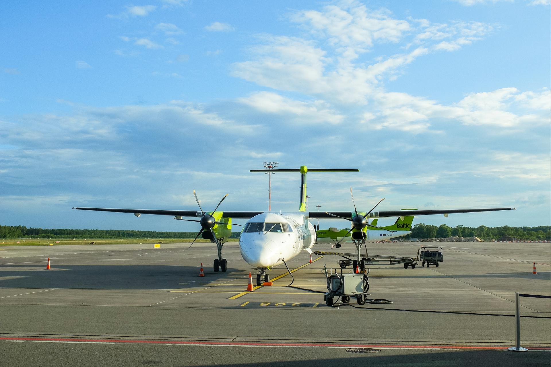 Plane Bombardier Dash 8 Q400 of Latvian airBaltic Airlines Refueling at the Airport