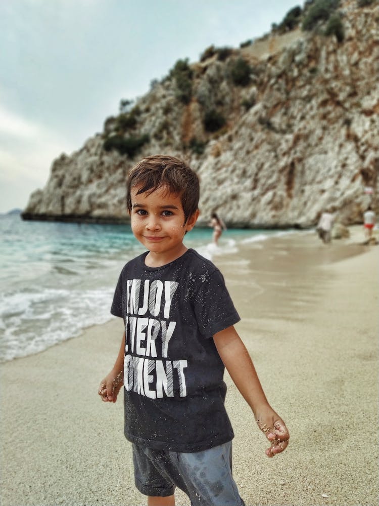 Little Boy Standing On Beach