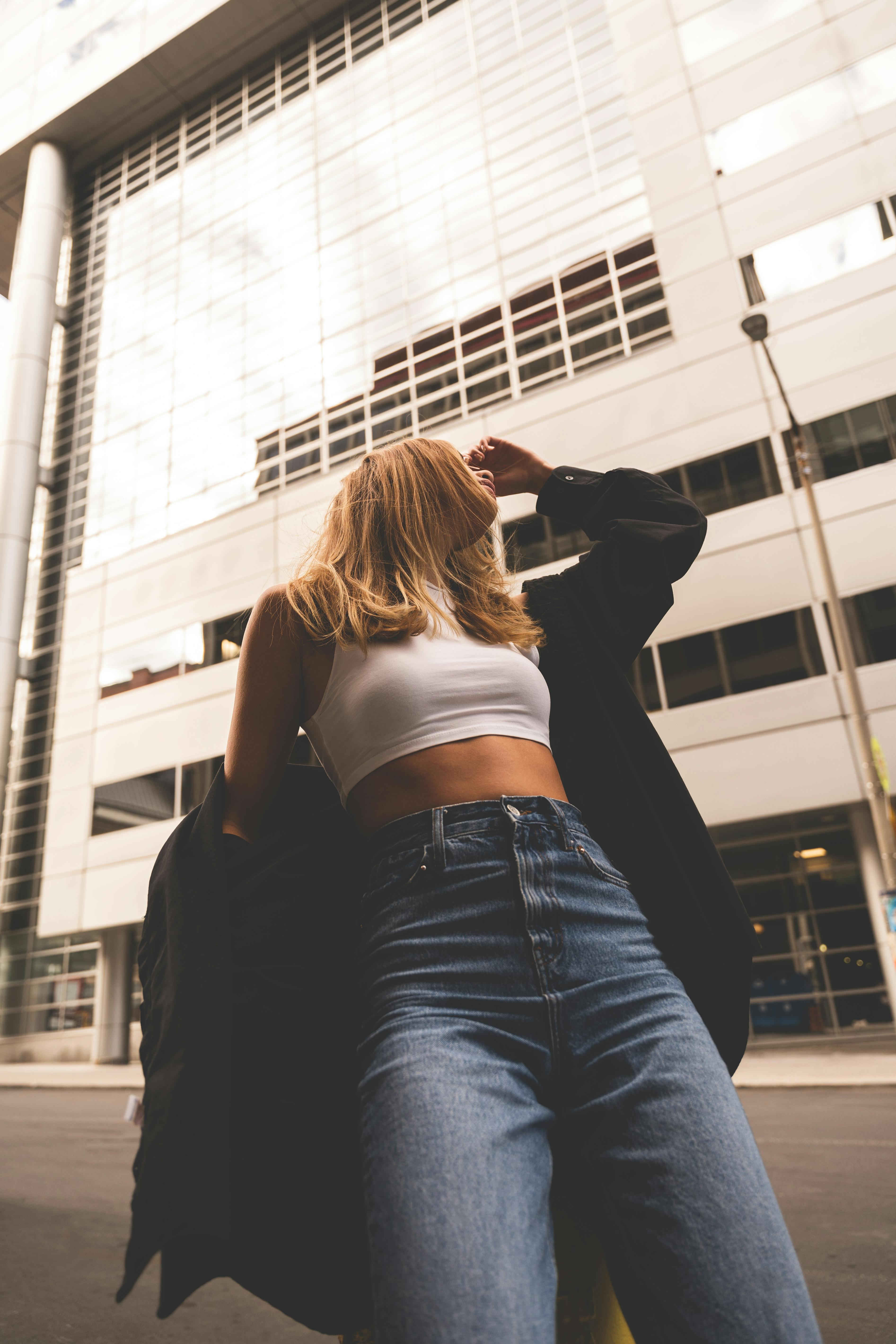 Woman Wearing A White Crop Top And Denim Pants · Free Stock Photo