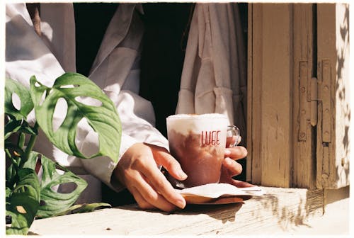 Free Person Holding a Cup of Coffee Stock Photo