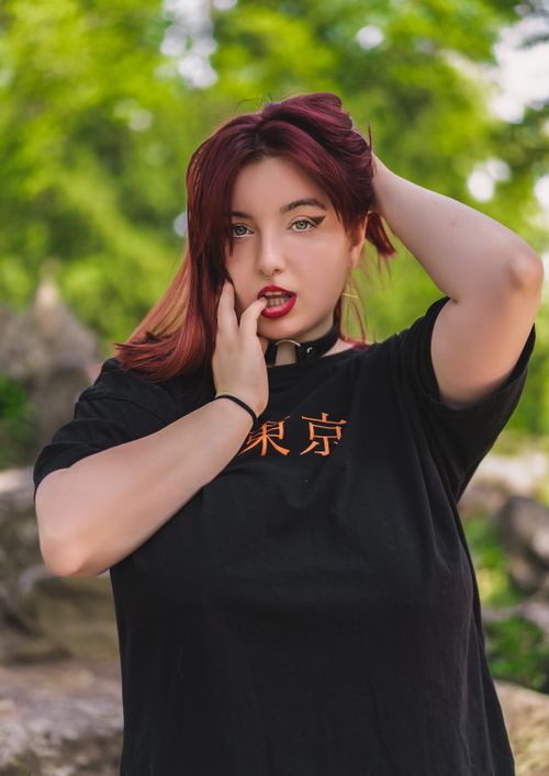 Free Portrait of a stylish young woman with colored hair posing confidently outdoors. Stock Photo