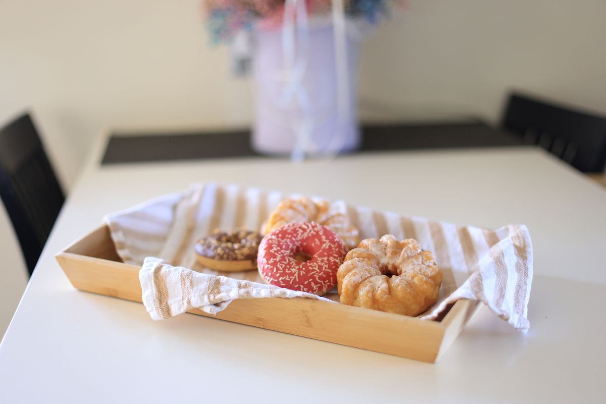 a single soft white donut on a clinical metal tray