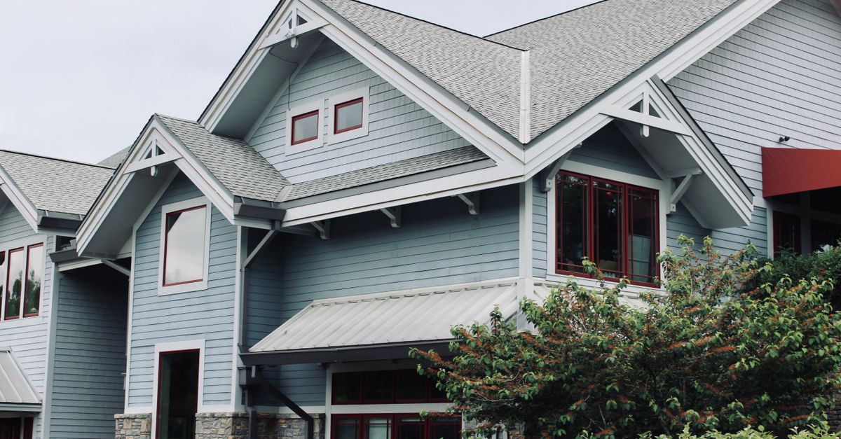 Charming blue house exterior with modern architectural features in Asheville, NC.