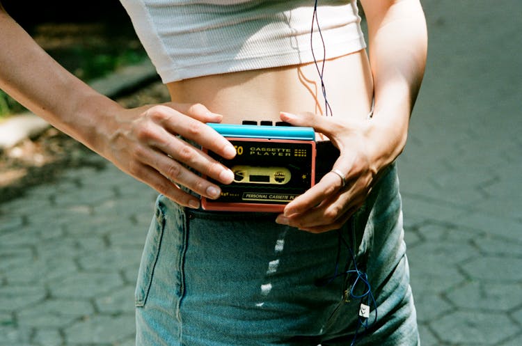 Unrecognizable Girl Switching On Portable Cassette Recorder