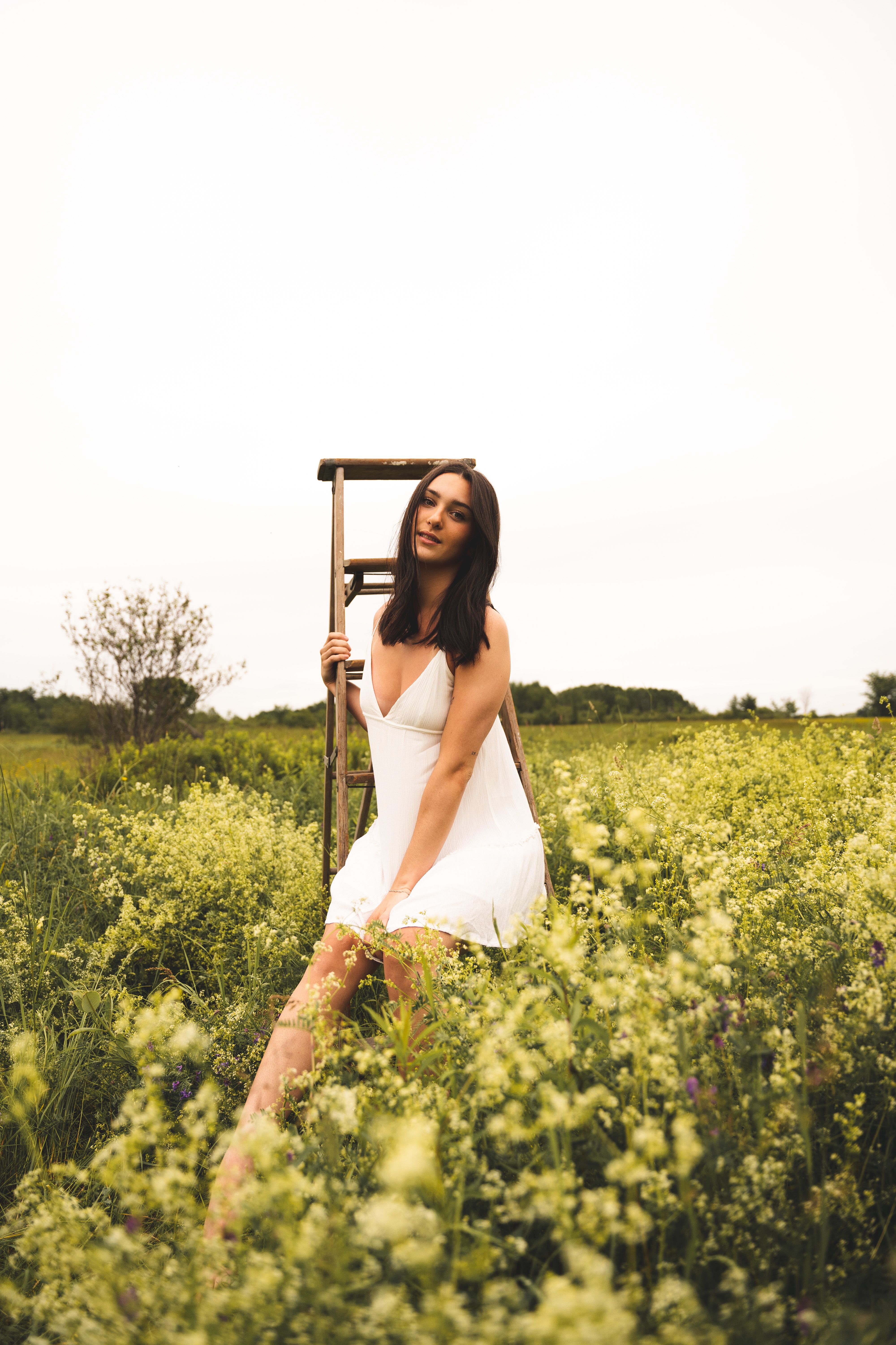 Woman in White Dress Sitting on a Ladder · Free Stock Photo